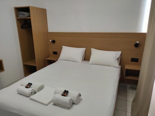 a bedroom with a bed with two towels on it at SMAROULA in Elafonisi