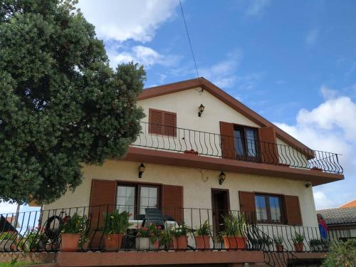 a house with balconies and plants in front of it at Sousa e Inês House in Gafanha da Nazaré