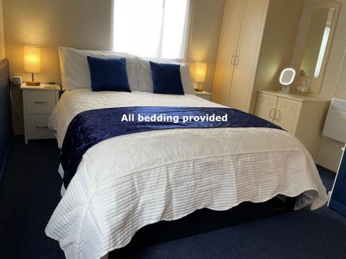 a bedroom with a bed with a blue and white blanket at Forest View - Adults Only - Maximum 2 Guests in Drumnadrochit