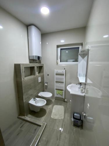 y baño con 2 lavabos, aseo y espejo. en Apartmani Venci Travnik en Travnik