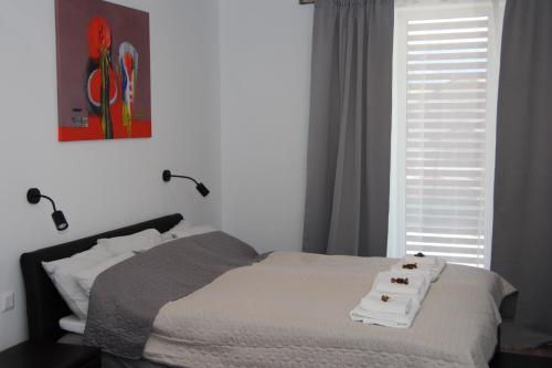 a bedroom with a bed with towels on it at APARTMÁN K2 Zuberec in Zuberec