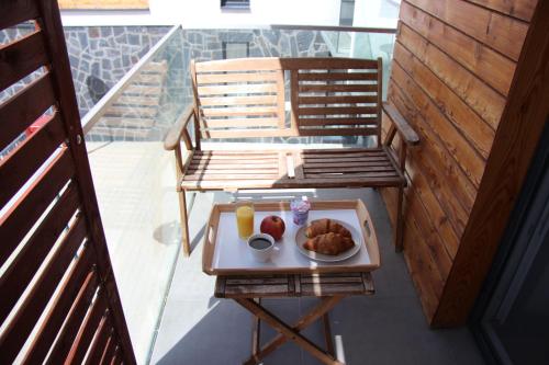 a tray of food on a table on a balcony at APARTMÁN K2 Zuberec in Zuberec