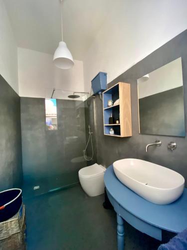 a bathroom with a sink and a toilet at Casa Marietta in San Vito lo Capo