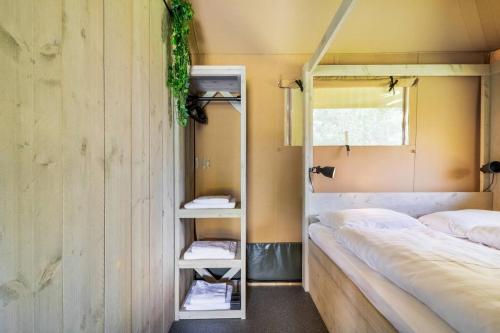 a room with two bunk beds and a window at Glamping lodge with Eco-Wellness in Zeewolde