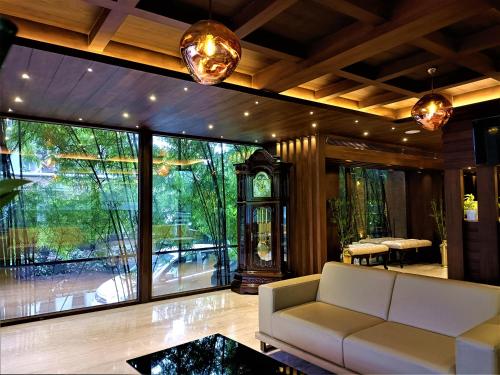 a living room with a white couch and a large window at Retrieve Health & Wellness in Cochin