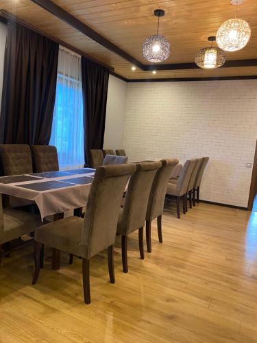 a dining room with a table and chairs at Mountain Residence in Tukhlya