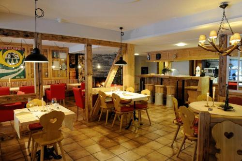 a restaurant with tables and chairs and a kitchen at Hotel Schützen Lauterbrunnen in Lauterbrunnen
