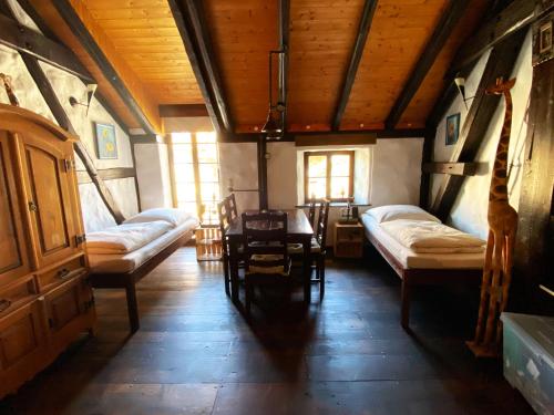 a room with two beds and a table and chairs at Ferienhaus NAMIBIA-LODGE im Rittergut Leppersdorf bei Dresden in Wachau