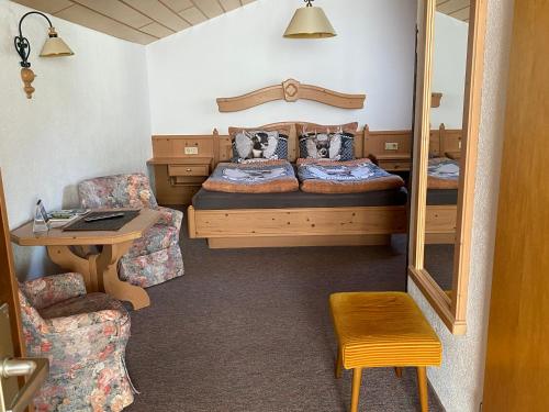 a bedroom with a bed and a table and a desk at Tiefenbrunn in Ehenbichl