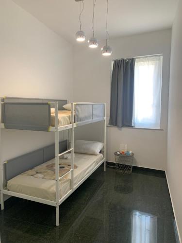 a room with two bunk beds and a window at I Venti in Brucoli