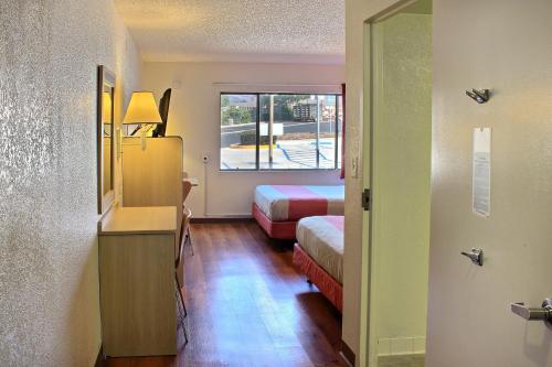 a small room with two beds and a window at Motel 6 San Simeon, CA - Hearst Castle Area in San Simeon