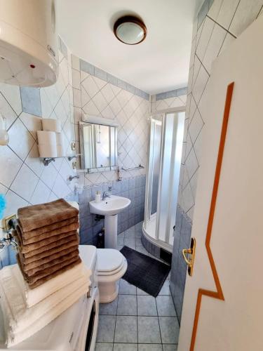 a bathroom with a white toilet and a sink at Apartment Iva in Klek