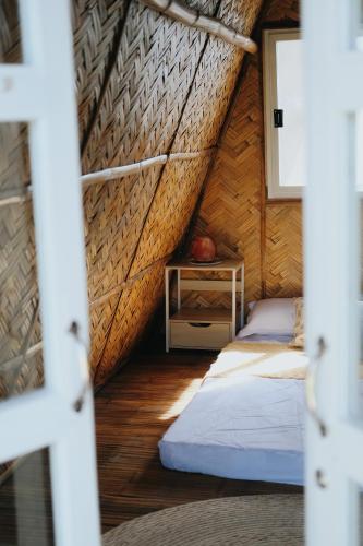 a bedroom with two beds and a table in a room at Urban Oasis Resort, Tarlac in Tarlac