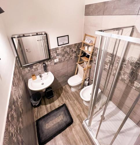 a bathroom with a shower and a toilet and a sink at Kofler GuestHouse in Barletta