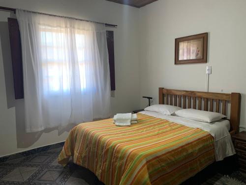 Säng eller sängar i ett rum på Casa Vista para Serra