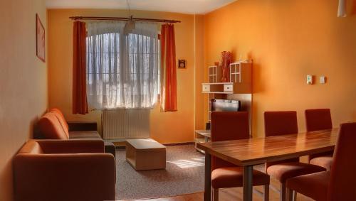 a living room with a table and chairs and a window at Apartmán Vysoké Tatry Lomnica A4/2 in Veľká Lomnica