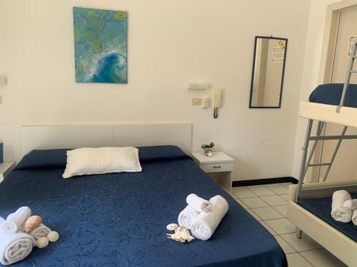 ein Schlafzimmer mit einem Bett mit Handtüchern darauf in der Unterkunft HOTEL LA PERGOLA in Cattolica