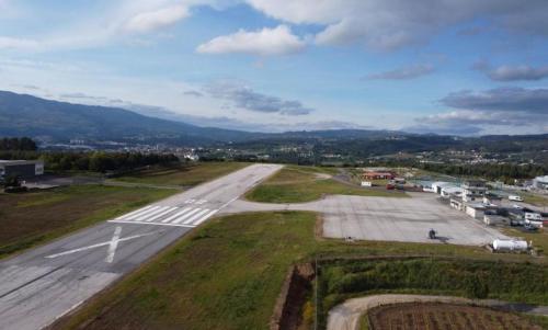 an empty runway in an airport with a town at SOFT ROOMS in Vila Real