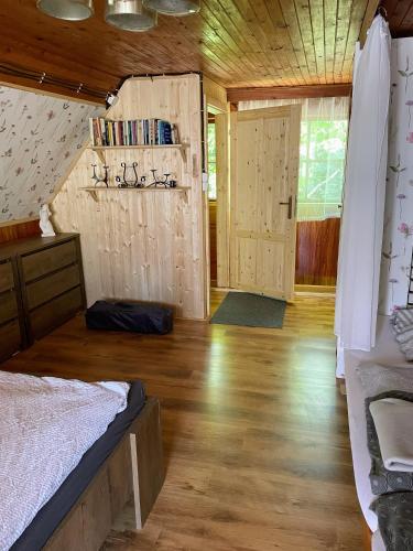a bedroom with a bed and a wooden floor at Chata Dagmar in Třebíč