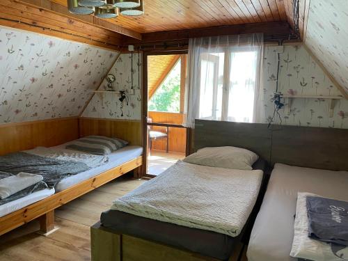 a room with two beds and a window at Chata Dagmar in Třebíč
