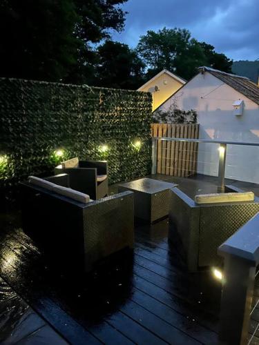 a patio with benches and lights at night at 4-6 Guests in centre location with stunning views in Llanberis