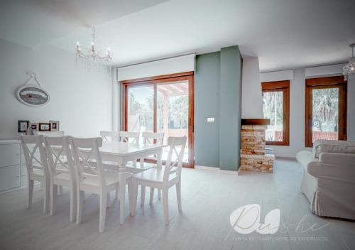a white dining room with a white table and chairs at PUSHE Village Playa Granada Beach&Golf 2 in Motril