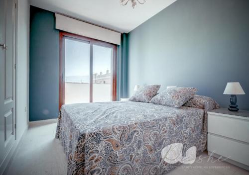 a bedroom with a bed and a large window at PUSHE Village Playa Granada Beach&Golf 2 in Motril