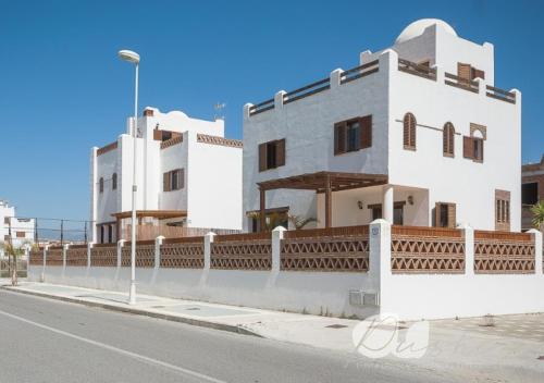 a white building on the side of a street at PUSHE Village Playa Granada Beach&Golf 2 in Motril