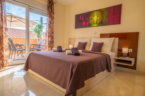 a bedroom with a bed and a balcony at La Dama in Novi Vinodolski