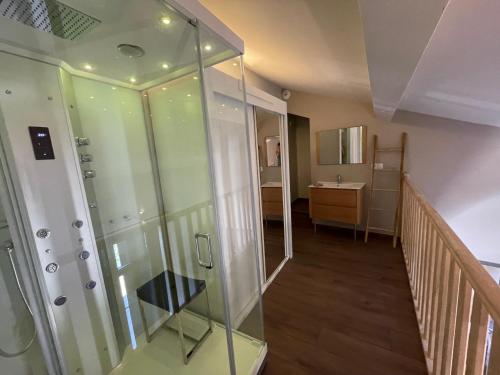 a bathroom with a walk in shower and a staircase at La Maison de l'Olivier in Avignon