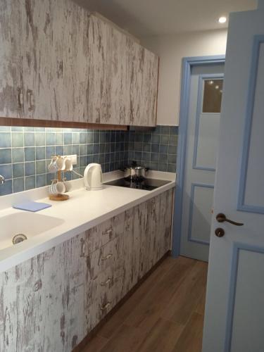 a kitchen with a sink and a counter top at Artistic house in Kokkari