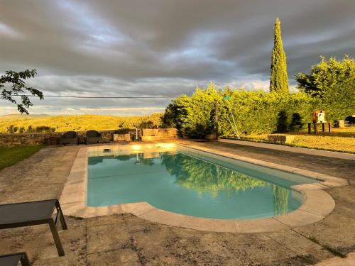 a swimming pool in a yard with a landscaping at casa rural de un artista en plena naturaleza piscina y parque de esculturas en villarcayo in Villarcayo
