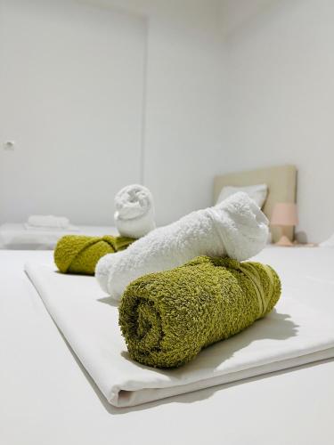 a row of towels sitting on top of a bed at Orea Hotel in Himare