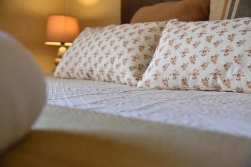 a bed with two pillows on top of it at San Pawl B&b farmhouse- KORTOLL in Tal-Barmil