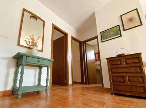 a room with a blue table and a dresser at Apartamento rural el Vidre VT-42035-CS in Vistabella del Maestrazgo