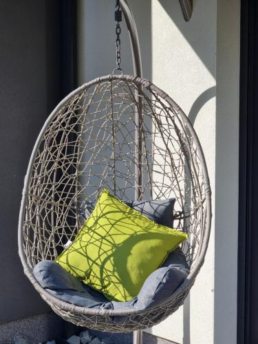 a hanging basket with a green pillow in it at Apartament Wiślańskie Skije in Wisła