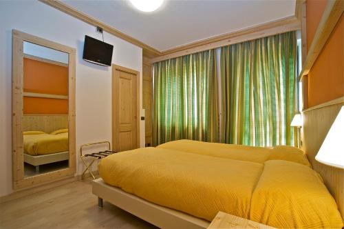 En eller flere senge i et værelse på Hotel Franca