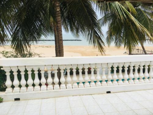 a white fence with a beach in the background at West AFRICAN BEACH in Sali Nianiaral