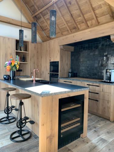 a kitchen with a large island in the middle at Vakantiewoning 't Rysselhof in Kaprijke
