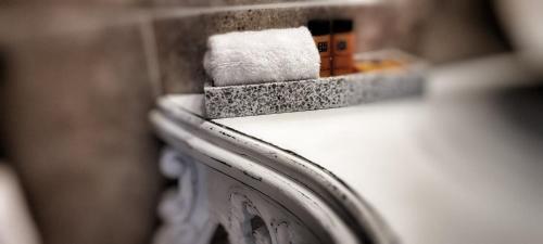 a close up of a bathroom counter with towels at MANOIR LE COUTUREAU maisons d'hôtes in Rouffignac-de-Sigoulès