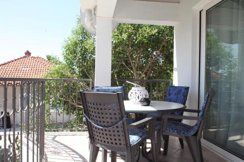 a porch with a table and chairs on a balcony at House Tena in Zaton