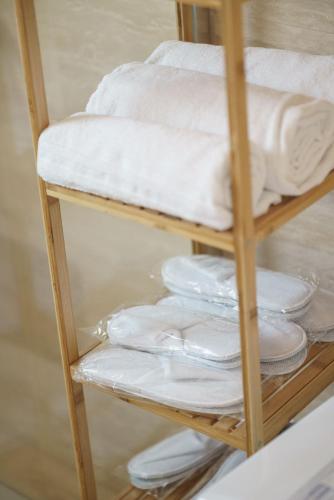 a shelf filled with white towels and towels at Vila Regina Apartment Regina with Swimming Pool in Jezera