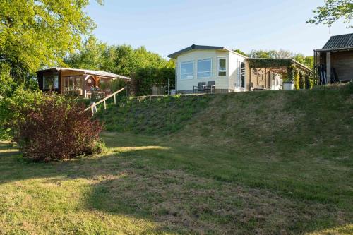 a house sitting on top of a grassy hill at Chalet Regge in Giethmen