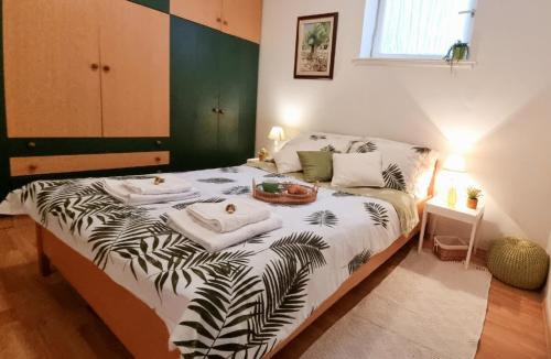 a bedroom with a bed with towels on it at Biba Apartman in Petrcane