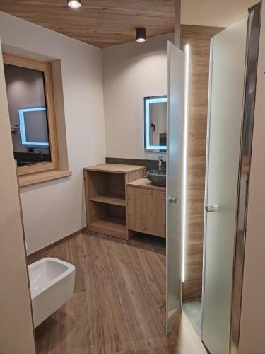 a bathroom with a sink and a toilet at Chalet MAOL Luxury Living in Valdidentro