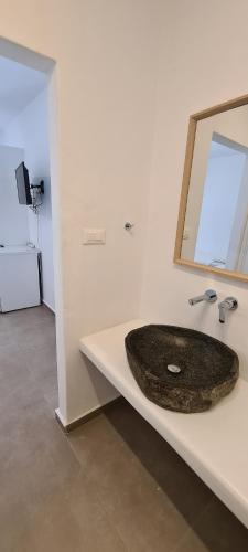 a bathroom with a sink and a mirror at Eternal Town in Mikonos
