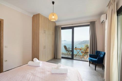 a bedroom with a bed and a view of the ocean at Irida sunset in Pentátion