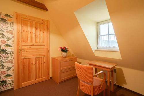 a room with a desk and a window and a dresser at APARTMÁNY V PARKU in Lednice