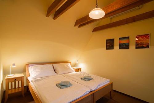 a bedroom with a bed with two towels on it at APARTMÁNY V PARKU in Lednice