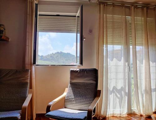 a room with two chairs in front of a window at Apartamento rural el Vidre VT-42035-CS in Vistabella del Maestrazgo
